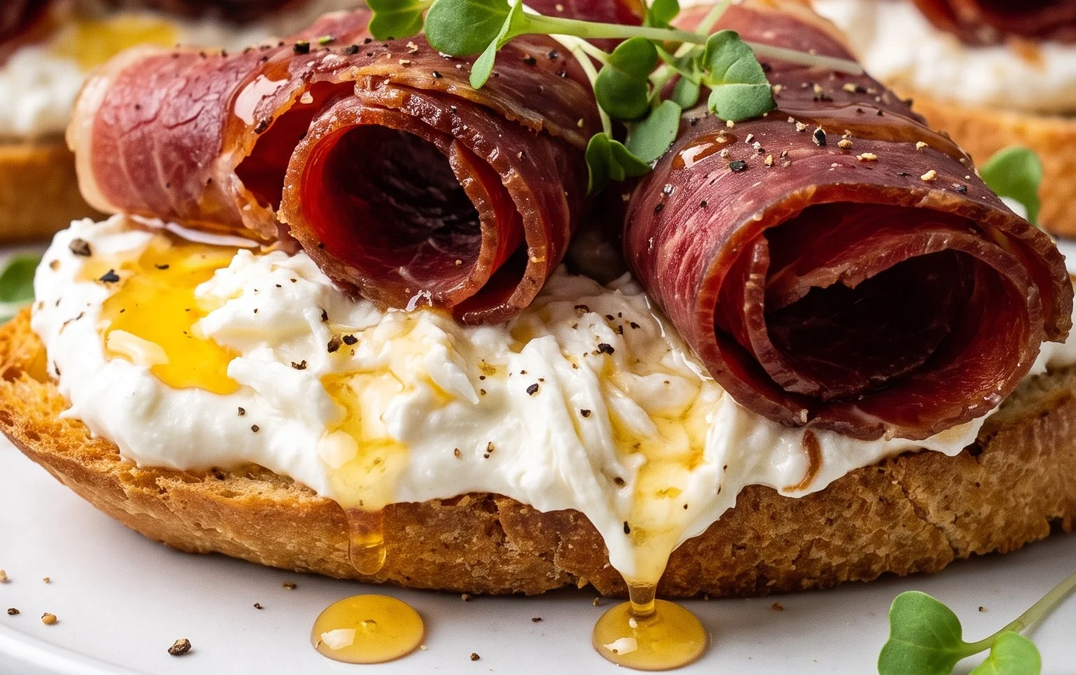 Beef Prosciutto Crostini with Burrata and Lemon Honey Drizzle